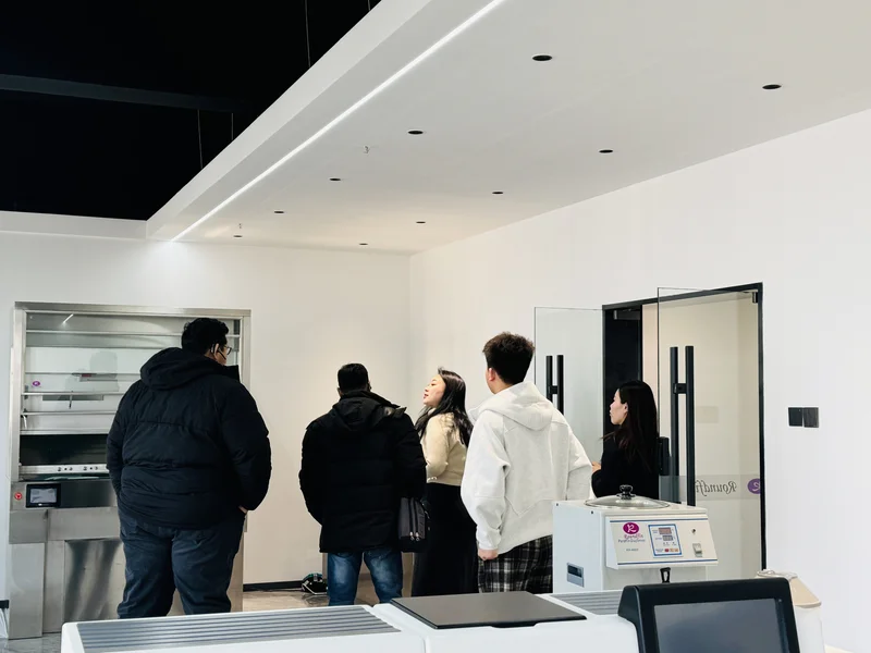 Customer visiting Roundfin showroom - inspecting mortuary equipment