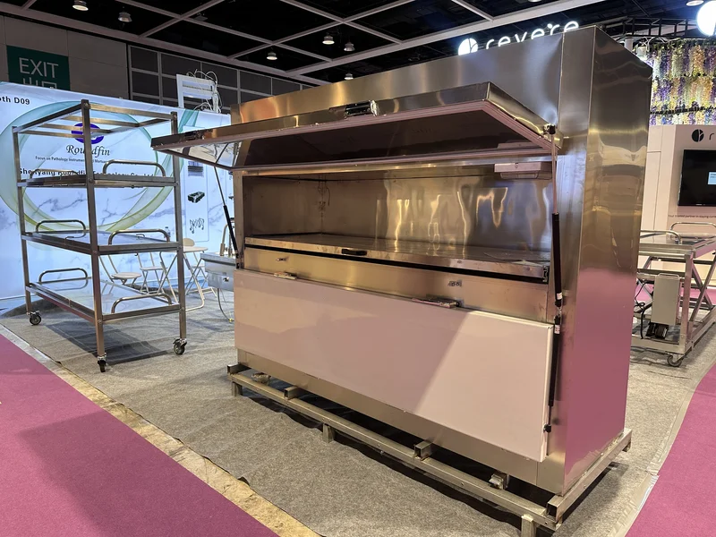 Roundfin team presenting mortuary equipment at AFE 2024 exhibition booth