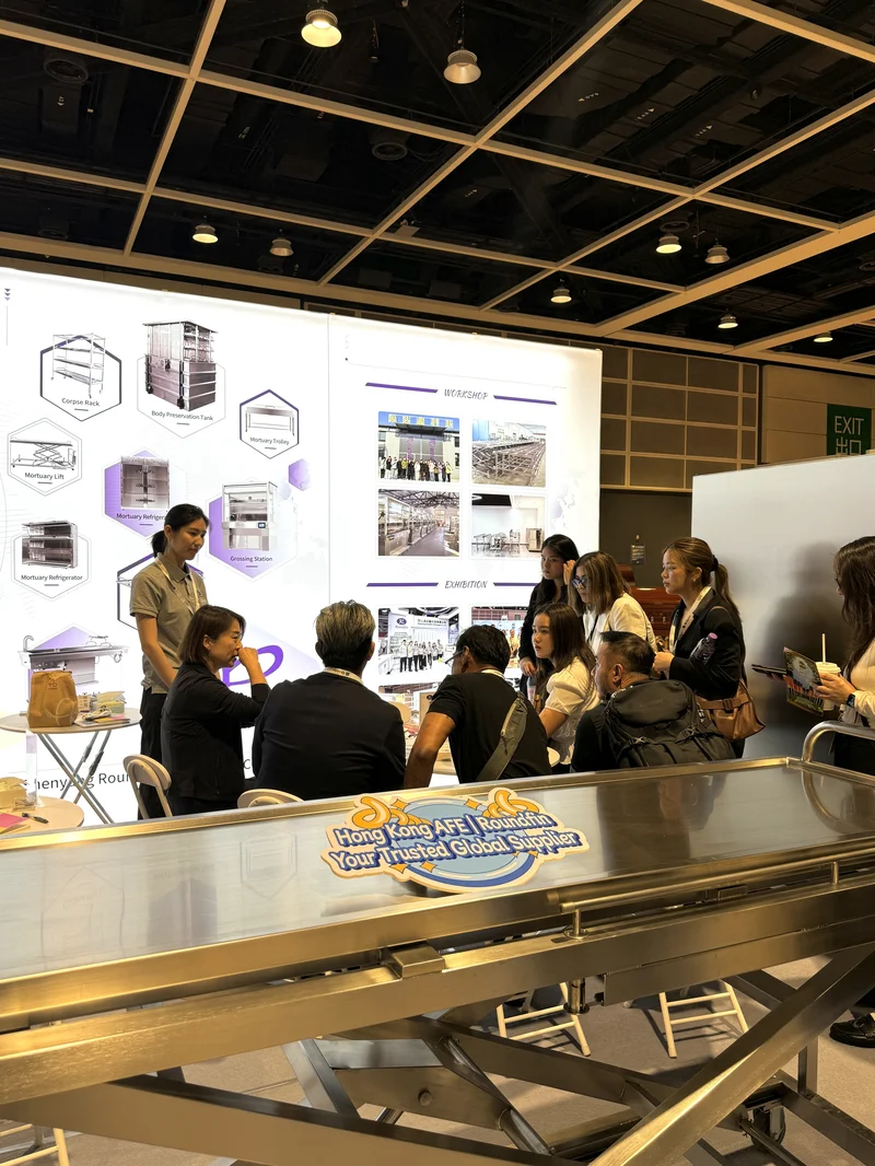 Roundfin exhibition booth at AFE Hong Kong 2026 featuring mortuary refrigerator, body lift, and autopsy table