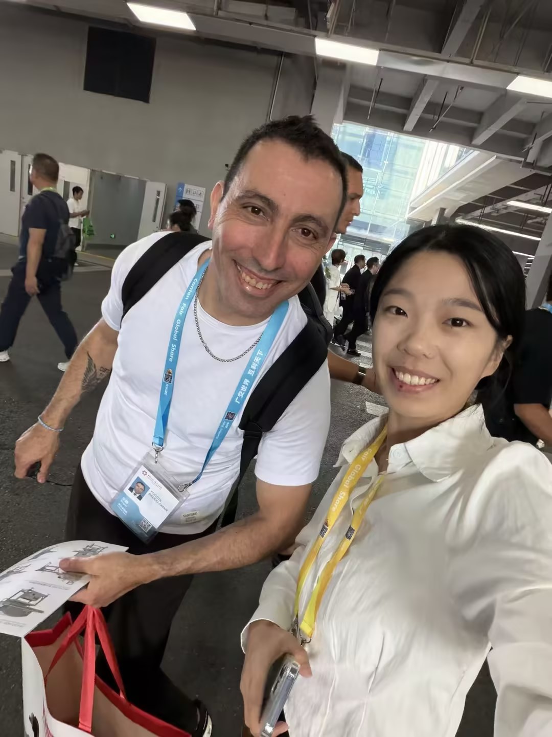Henco staff with a buyer holding the product catalogue at the 140th Canton Fair in Guangzhou